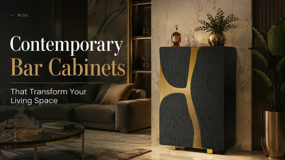 ARGMAC Flusso liquor cabinet in textured charcoal with a sweeping gold inlay, topped with a decanter and glasses, set against a marble wall beside a big brass planter and greenery.