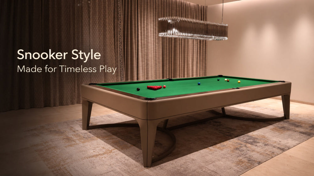 ARGMAC luxury snooker table with green snooker cloth and leather frame, set up for snooker balls and cue play under a crystal chandelier in a refined home game room.