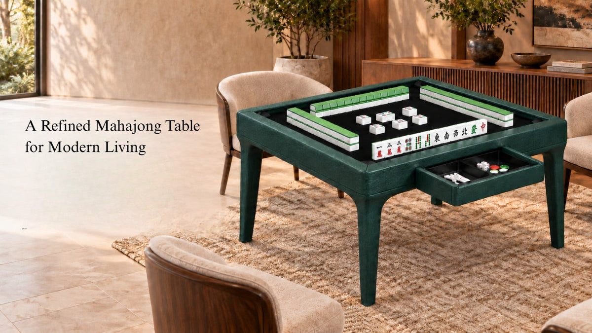 ARGMAC mahjong table in deep green textured leather with a mahjong tile set laid out on black felt, a pull-out drawer holding dice and chips, set in a sunlit luxury living room.