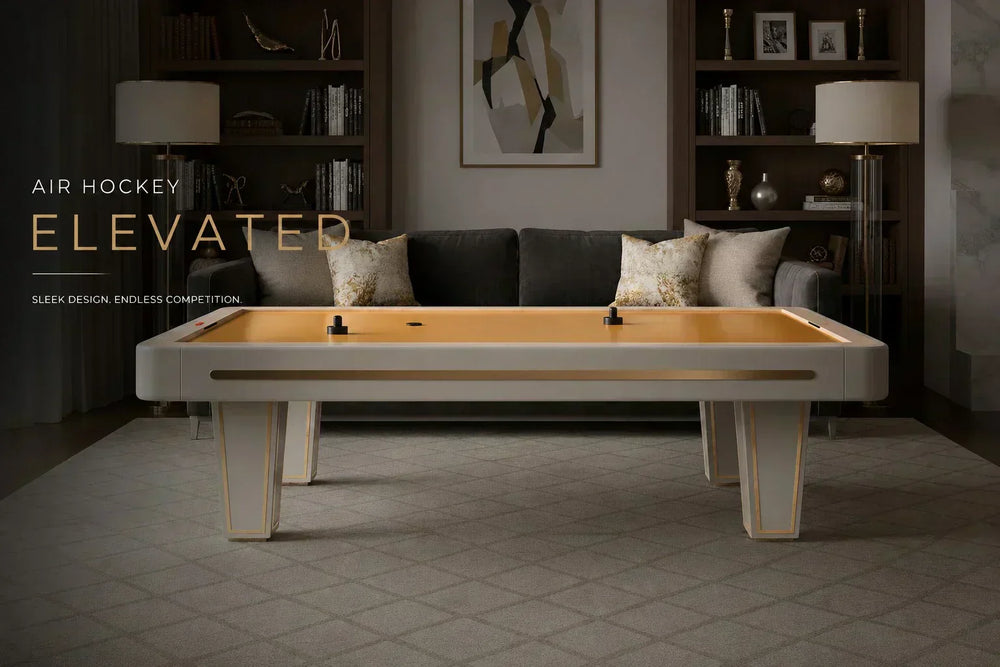 Luxury air hockey table integrated into a sophisticated home lounge with custom shelving, designer furnishings, and refined finishes, creating an elevated indoor gaming experience.