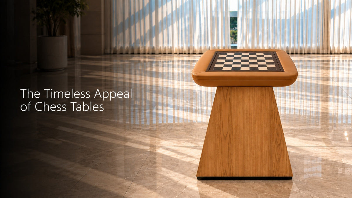 ARGMAC Monolith Axis chess table with a leather-wrapped chess table top and inlaid wooden board on a tapered oak chess stand, set on a marble floor in a sunlit room