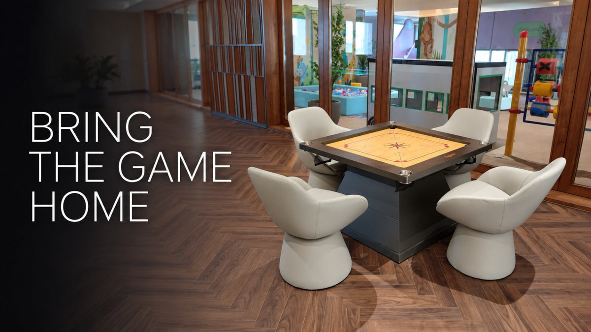 ARGMAC carrom table with a cream playing surface set on a dark wood carrom stand with four corner pockets, paired with four cream swivel chairs on an indoor herringbone floors.